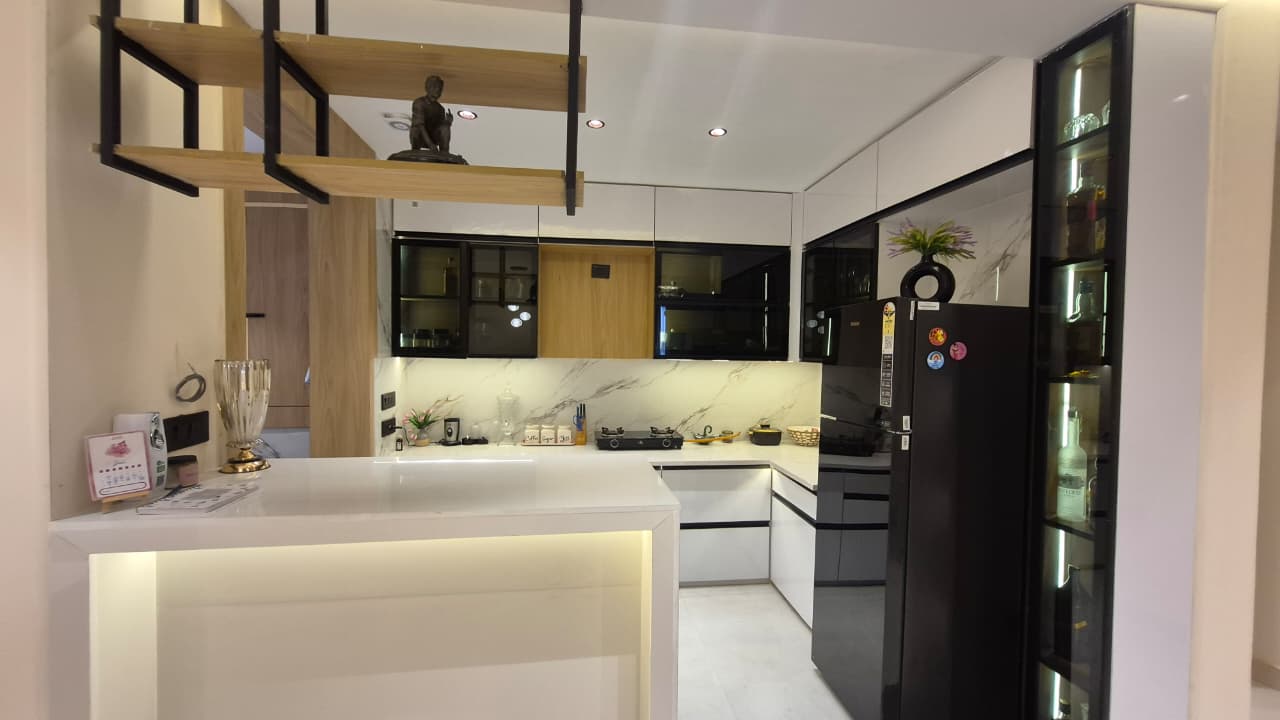 Modern white handleless kitchen with quartz countertops and breakfast bar